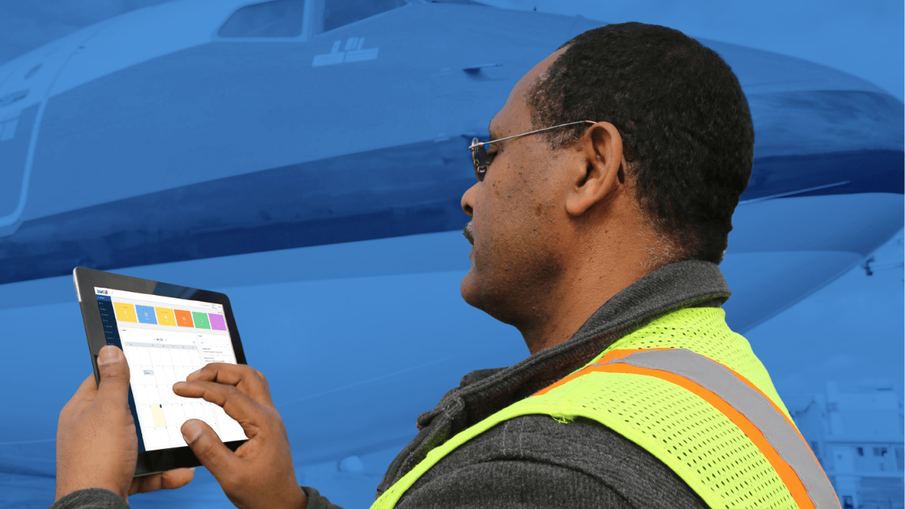 Aviation MRO technician using ERP system tablet in repair station maintenance workflow